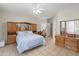 Spacious main bedroom with tile flooring, ceiling fan, and built-in dresser with mirror at 4272 E Ivanhoe St, Gilbert, AZ 85295