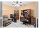 Traditional home office with wooden desk, storage cabinet, desk chair, ceiling fan and exercise bike at 4272 E Ivanhoe St, Gilbert, AZ 85295