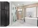 Modern bathroom with sleek cabinets, a glass shower enclosure, a soaking tub, and stylish fixtures at 441 S Dodge Dr, Chandler, AZ 85225