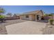 A backyard with a block wall, covered patio, and a brick paved patio in the foreground at 4517 N 123Rd Dr, Avondale, AZ 85392