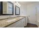 Bright bathroom with granite countertops, dual sinks, and a dark wood floor at 4517 N 123Rd Dr, Avondale, AZ 85392