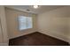 A simple bedroom featuring hardwood floors and a window with coverings at 4517 N 123Rd Dr, Avondale, AZ 85392