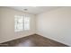 Bright bedroom featuring a window with blinds and hardwood-style flooring at 4517 N 123Rd Dr, Avondale, AZ 85392