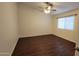 A simple bedroom featuring hardwood floors, a ceiling fan and a window with coverings at 4517 N 123Rd Dr, Avondale, AZ 85392