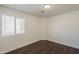 Well-lit bedroom features a large window and hardwood-style flooring at 4517 N 123Rd Dr, Avondale, AZ 85392