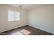 Bright bedroom featuring a window with blinds and hardwood-style flooring at 4517 N 123Rd Dr, Avondale, AZ 85392