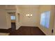 Well-lit dining room features wood floors and a modern chandelier at 4517 N 123Rd Dr, Avondale, AZ 85392