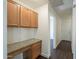 Hallway with wooden cabinets, light granite countertop and access to an exterior door at 4517 N 123Rd Dr, Avondale, AZ 85392