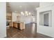 Well-lit open kitchen featuring stainless steel appliances, granite countertops, and a view into the living room at 4517 N 123Rd Dr, Avondale, AZ 85392