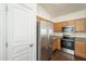 Modern kitchen featuring stainless steel appliances, wood cabinets, and granite countertops providing ample storage and style at 4517 N 123Rd Dr, Avondale, AZ 85392