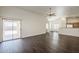 Bright living room with wood-look floors, sliding glass doors and a ceiling fan, creating an inviting space at 4517 N 123Rd Dr, Avondale, AZ 85392