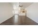 Open-concept living space showcasing wood-look floors, white walls, and seamless flow into the dining area and kitchen at 4517 N 123Rd Dr, Avondale, AZ 85392