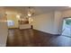 Open-concept living room with hardwood floors, a ceiling fan and lots of natural light at 4517 N 123Rd Dr, Avondale, AZ 85392