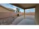 A covered patio is situated in a gravel backyard with a view at 4517 N 123Rd Dr, Avondale, AZ 85392