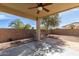 Covered patio with a ceiling fan overlooking a spacious backyard with a grill at 45341 W Paraiso Ln, Maricopa, AZ 85139