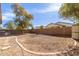 Spacious backyard with gravel landscaping, block wall fencing, and mature trees at 45341 W Paraiso Ln, Maricopa, AZ 85139