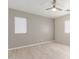 Bright bedroom with a ceiling fan, neutral paint, light-colored wood floors and two windows at 45341 W Paraiso Ln, Maricopa, AZ 85139