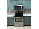 Up close view of kitchen with stainless steel appliances and custom backsplash at 45341 W Paraiso Ln, Maricopa, AZ 85139