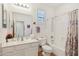 Bathroom with single sink vanity, combined shower and tub, and shuttered window at 4627 E Sourwood Dr, Gilbert, AZ 85298