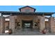 The San Tan Club entrance features stone columns and an inviting, covered entryway at 4627 E Sourwood Dr, Gilbert, AZ 85298