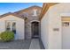 Charming home exterior with a stone facade, arched entryway, and well-manicured landscaping at 4627 E Sourwood Dr, Gilbert, AZ 85298