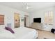 Bright bedroom with neutral tones, ceiling fan, dresser, and attached bath for a comfortable, modern retreat at 4627 E Sourwood Dr, Gilbert, AZ 85298