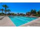 Resort-style pool with lap lanes, palm trees, lounge chairs, and umbrellas on a sunny day at 4627 E Sourwood Dr, Gilbert, AZ 85298