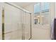 Modern bathroom featuring glass-enclosed shower with a window providing natural light at 4627 E Sourwood Dr, Gilbert, AZ 85298