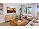 Comfortable living room featuring a wooden coffee table, chairs, and a decorative TV display at 4752 E Topaz Dr, San Tan Valley, AZ 85140