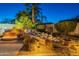 Gorgeous backyard water feature with illuminated rock and greenery, adding a tranquil ambiance to the outdoor space at 4756 W Nogales Way, Eloy, AZ 85131