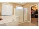 Bathroom featuring a soaking tub, glass enclosed shower, and access to a walk-in closet at 4756 W Nogales Way, Eloy, AZ 85131