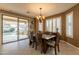 Bright dining room featuring chandelier lighting, shuttered windows and backyard views at 4756 W Nogales Way, Eloy, AZ 85131