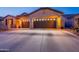 Beautiful home exterior highlighting the three car garage and desert landscaping at 4756 W Nogales Way, Eloy, AZ 85131