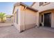 Exterior shot of home showing side entrance, stucco walls, and decorative shutters at 4756 W Nogales Way, Eloy, AZ 85131