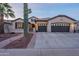 Charming home exterior showcasing a three car garage and desert landscaping at 4756 W Nogales Way, Eloy, AZ 85131