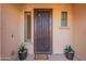 Elegant front entry with decorative security door, neutral walls, and potted succulents at 4756 W Nogales Way, Eloy, AZ 85131