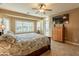 Comfortable main bedroom featuring tile flooring, a ceiling fan, and a TV cabinet at 4756 W Nogales Way, Eloy, AZ 85131