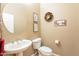 Neat powder room featuring a pedestal sink, neutral walls, and decorative wall art at 4756 W Nogales Way, Eloy, AZ 85131