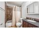 Cozy bathroom featuring tile accents, a vanity with storage, and a shower-tub combination at 4867 W Palo Verde Dr, Glendale, AZ 85301