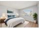 Staged bedroom with a white bed frame and a blue decorative pillow at 4867 W Palo Verde Dr, Glendale, AZ 85301