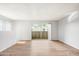 Spacious living room featuring hard surface flooring, white walls, and a sliding glass door to the outside at 4867 W Palo Verde Dr, Glendale, AZ 85301