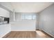 Open concept living room with wood flooring and a pass through to the kitchen at 4867 W Palo Verde Dr, Glendale, AZ 85301