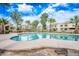 Community pool surrounded by lush landscaping with palm trees, perfect for relaxation and recreation at 4867 W Palo Verde Dr, Glendale, AZ 85301