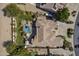 Aerial view shows a desert home with pool, lush landscaping, patio, and a putting green for recreation at 4915 N Greentree Dr, Litchfield Park, AZ 85340