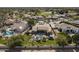 Aerial view of a desert community with pool, landscaping, and golf course in the distance at 4915 N Greentree Dr, Litchfield Park, AZ 85340