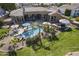 Aerial view showcases a backyard pool, spa, lounge area, BBQ, lush landscaping, and desert home at 4915 N Greentree Dr, Litchfield Park, AZ 85340