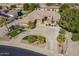 Stunning aerial view of a desert home with a circular driveway and lush landscaping, enhancing curb appeal at 4915 N Greentree Dr, Litchfield Park, AZ 85340