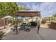 Relax under the shaded gazebo with string lights in this home's backyard patio, ideal for outdoor entertaining and relaxation at 4915 N Greentree Dr, Litchfield Park, AZ 85340