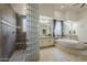 This bathroom features a glass block shower and a soaking tub at 4915 N Greentree Dr, Litchfield Park, AZ 85340