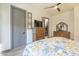 Well-lit bedroom featuring neutral walls, ceiling fan and doorway leading to the closet at 4915 N Greentree Dr, Litchfield Park, AZ 85340